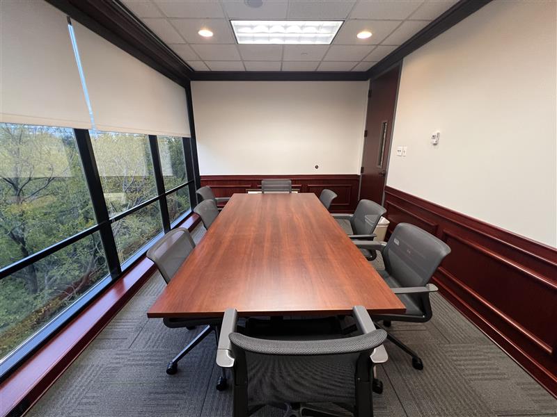 Conference room with a table, chairs and whiteboard